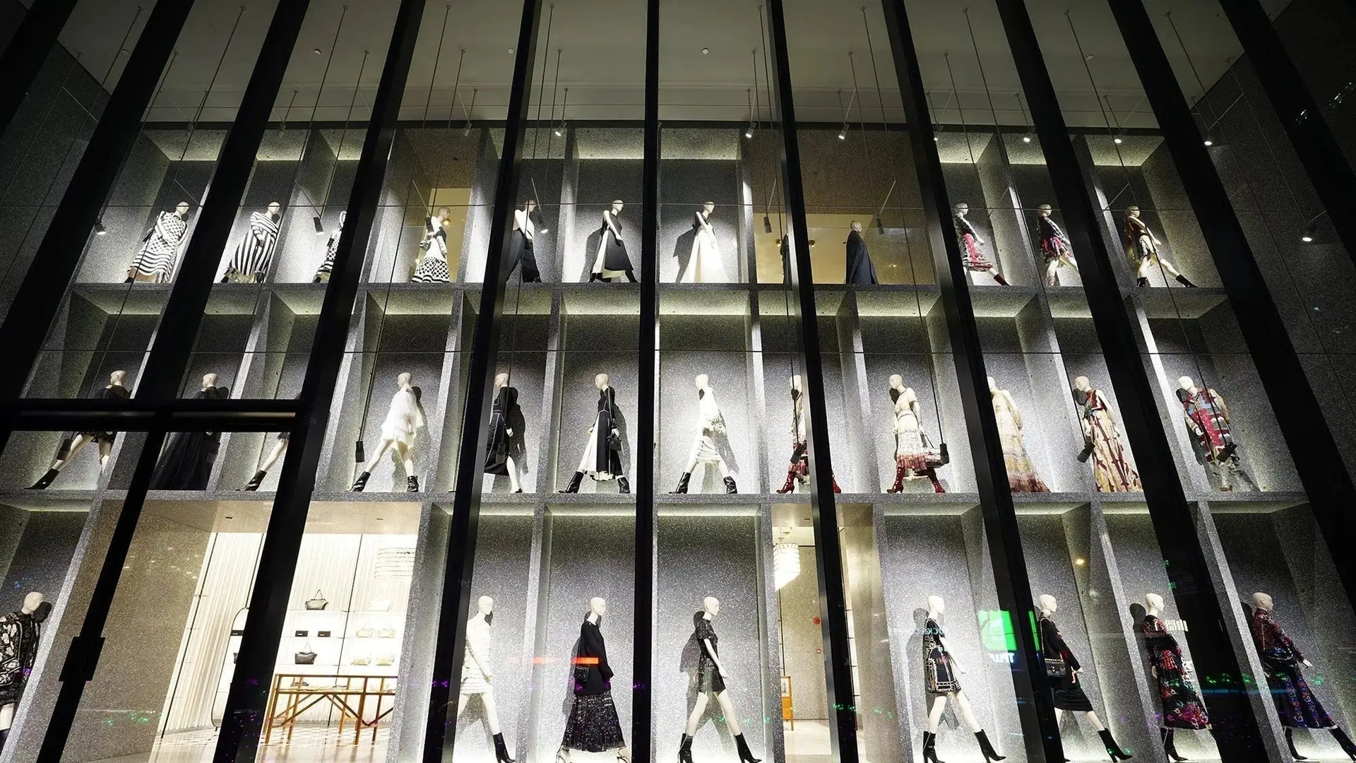 Modern multi-tiered mannequin display in new luxury fashion capital window