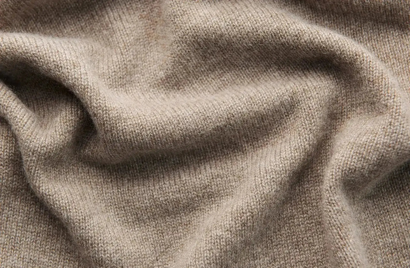 Soft beige cashmere knit with textured weave in luxury guide