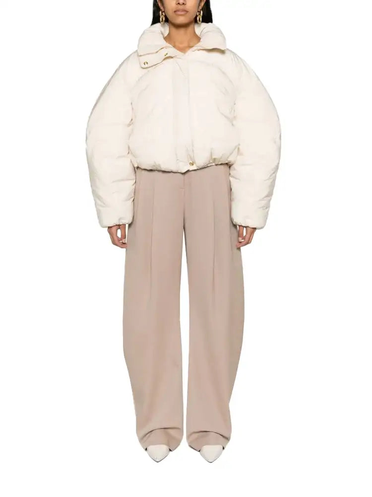 Cream-colored, puffy quilted down jacket with a high collar and button closure.