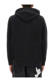Back side of 3.paradis men’s black hooded sweatshirt with white embroidered dove on lower back