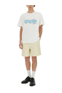 White t-shirt with light blue graffiti print paired with 3.paradis men’s beige twill shorts front view