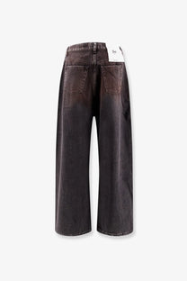 Back view of 3x1 women’s denim skater jeans gold in dark gray wide-leg denim with faded wash and classic back pockets