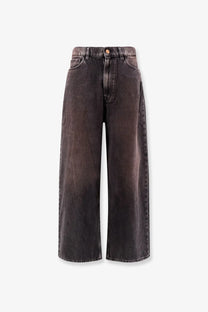 Dark gray wide-leg denim skater jeans with faded distressed finish and classic five-pocket design by 3x1 women