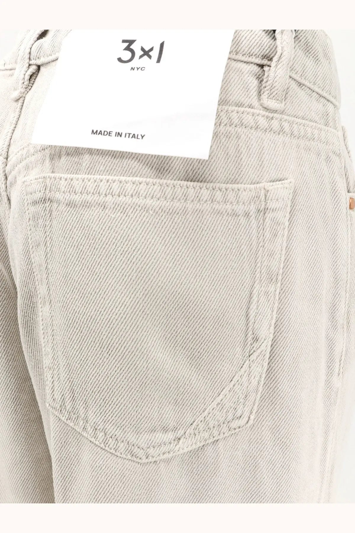 3x1 women’s flip beige denim trousers with light-wash five-pocket design and white 3x1 nyc brand tag on waistband
