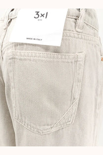 3x1 women’s flip beige denim trousers with light-wash five-pocket design and white 3x1 nyc brand tag on waistband