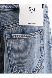 Back side of light-wash denim 3x1 women’s skater boyfriend jeans with classic pocket, contrasting stitching, and white label made in italy
