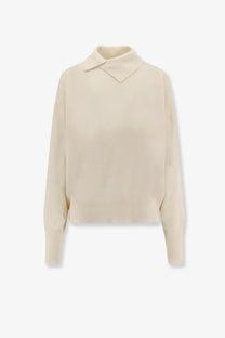 The 73 women’s turleneck wool sweater in cream features a knit collar and ribbed cuffs for warmth and style