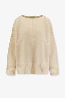The 73 women’s virgin wool sweater white is a cream-colored loose-fitting knit with ribbed cuffs hem side pockets and sleeve detailing