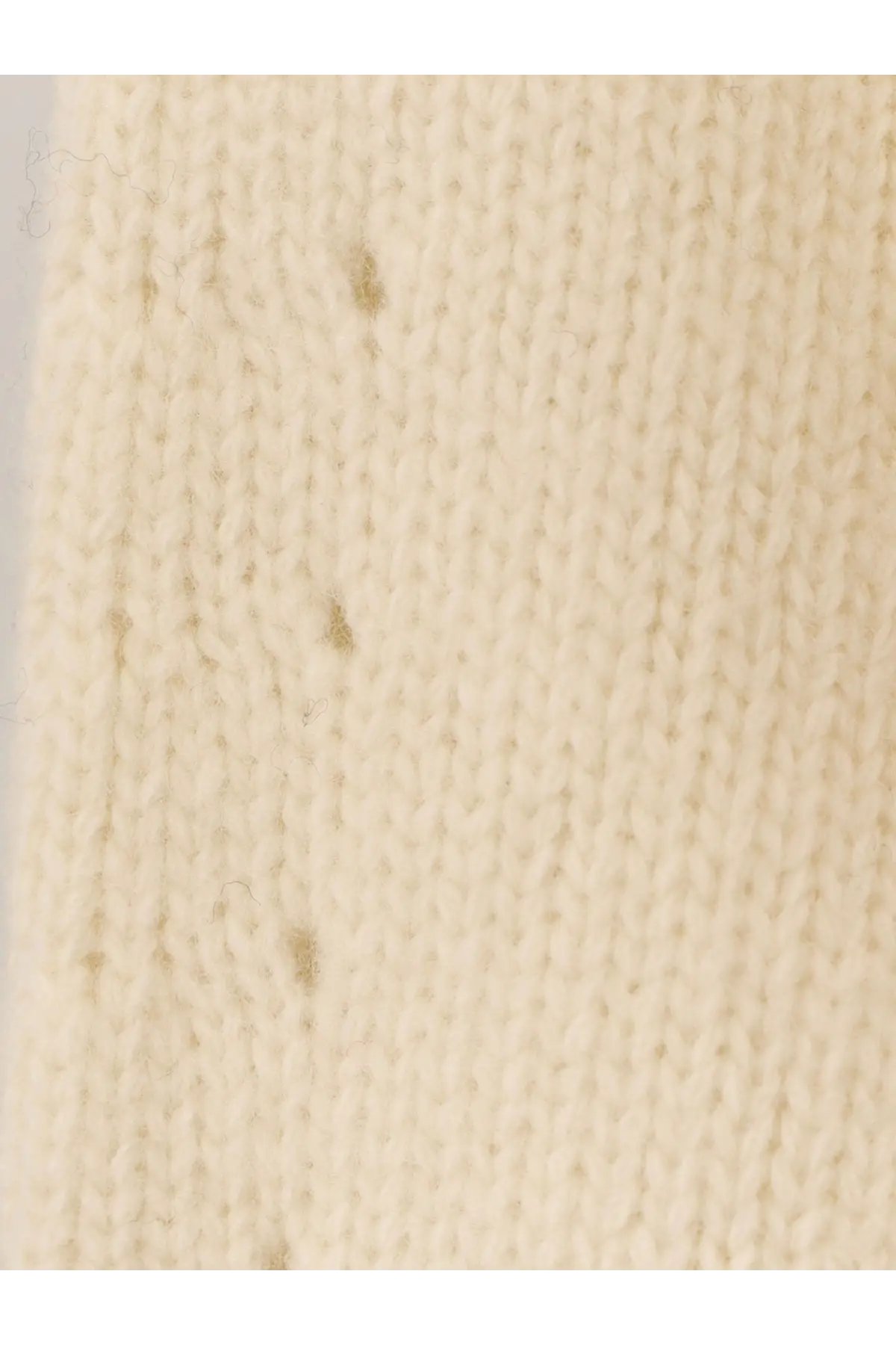 The 73 women’s virgin wool sweater white featuring cream-colored knitted fabric with ribbed texture and minor discoloration spots