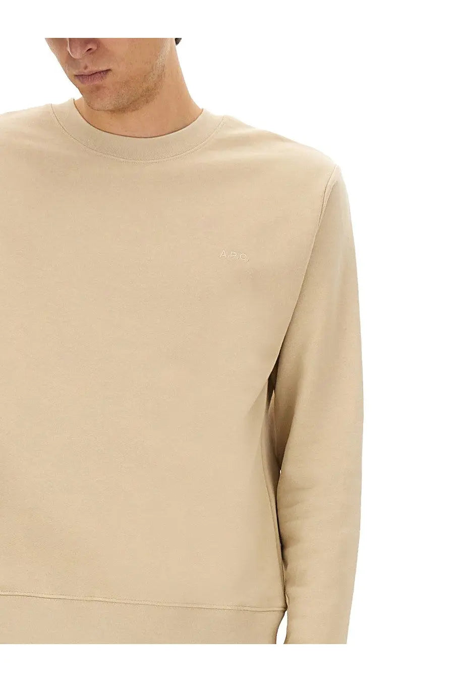Beige crewneck sweatshirt by a p c men with subtle embroidered logo on left chest in soft cotton material