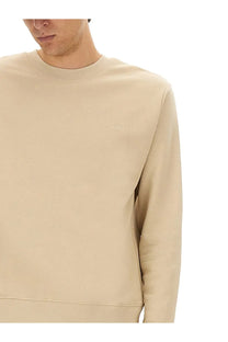 Beige crewneck sweatshirt by a p c men with subtle embroidered logo on left chest in soft cotton material