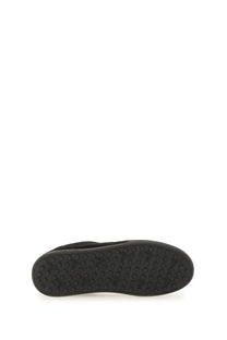 Black rubber sole of a p.c unisex sneaker moe black with textured circular tread pattern visible at the back