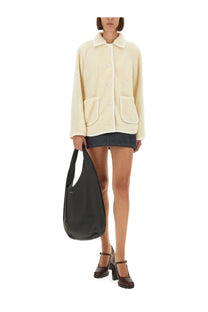 A black leather shoulder bag with minimalist design and subtle logo paired with a.p.c women’s blouson jacket estelle white