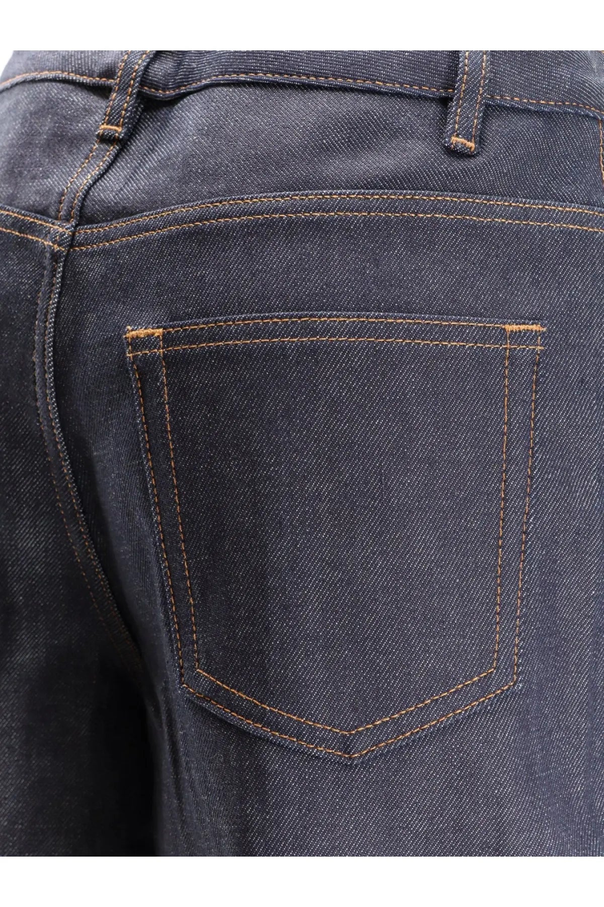 Back side of apc women’s elisabeth jeans in dark blue denim with contrasting tan stitching on the back pocket
