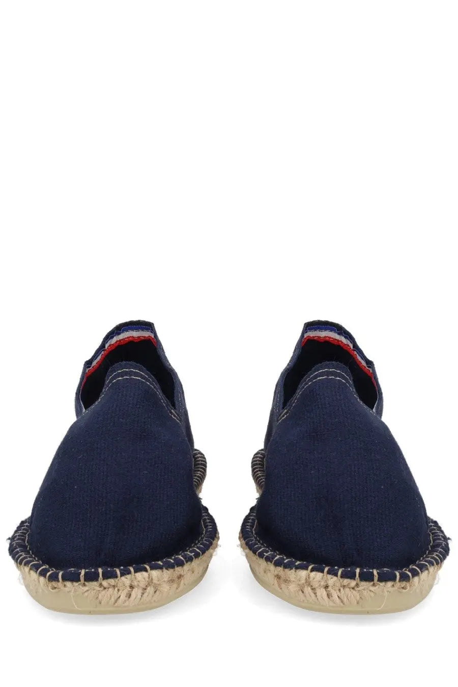 Navy blue apc women’s espadrilla slip-on shoes with woven jute sole and red white and blue striped heel trim back view