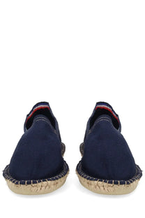 Navy blue apc women’s espadrilla slip-on shoes with woven jute sole and red white and blue striped heel trim back view
