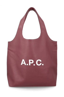 A maroon faux leather tote bag with bold white a.p.c. lettering on the front for women