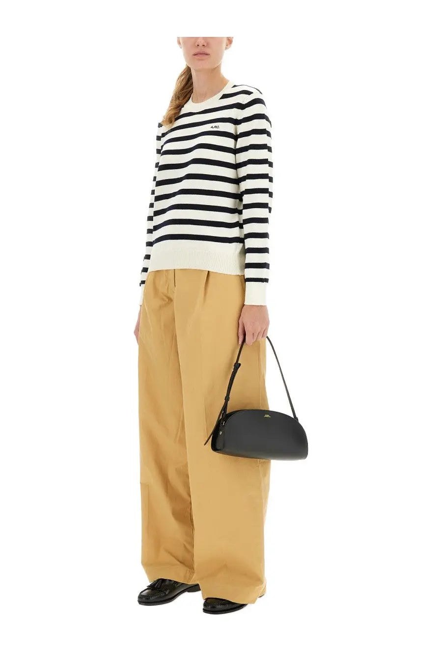Black leather crossbody bag with minimalist design and subtle logo detail featured with a.p.c women’s pants veronica yellow