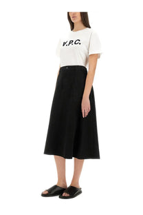 Black high-waisted midi skirt with front button closure and side pockets paired with a white apc women’s shirt