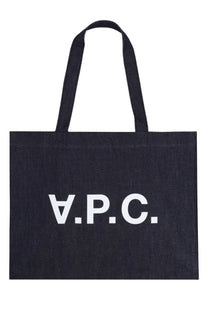 Black canvas A.P.C. tote bag with white lettering designed for women’s shopping use