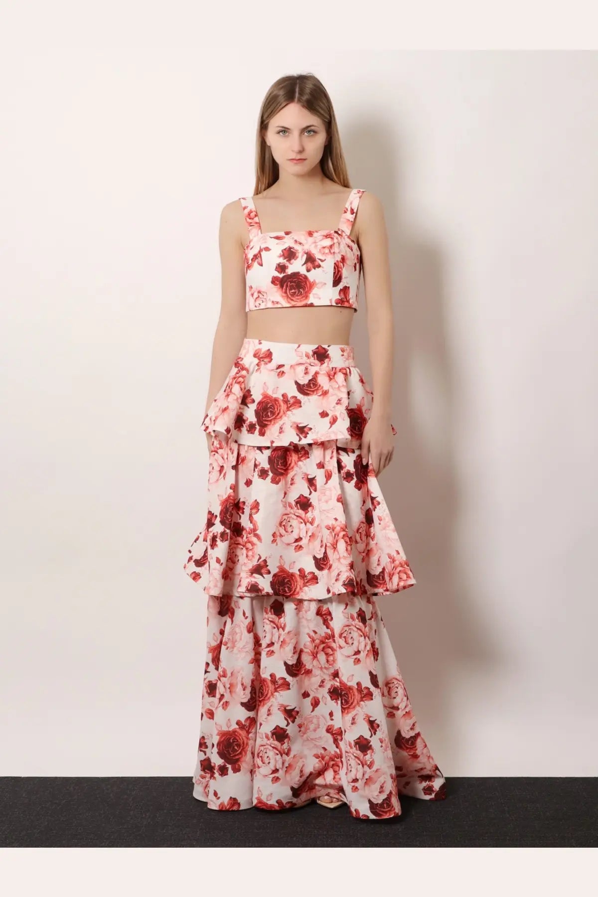 A woman wearing Actualee women’s flounced long skirt pink in a matching white crop top with red rose prints floral set