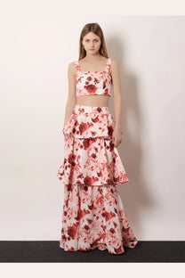 A woman wears actualee women’s flounced long skirt pink with a white crop top featuring red rose prints and floral pattern