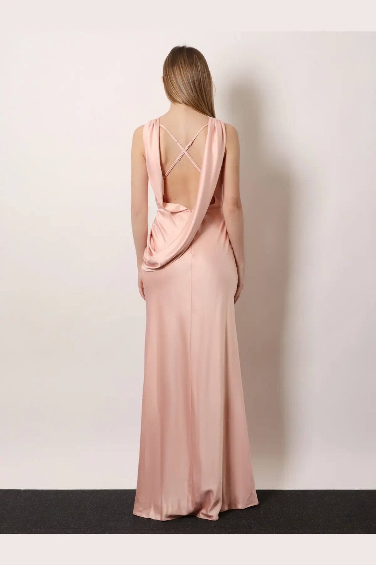 Actualee women’s satin long dress pink shown from the back with a flowing blush pink draped cross-back design