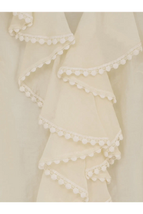 Actualee women’s white shirt with cream-colored ruffled fabric and delicate white pom-pom trim on each layer