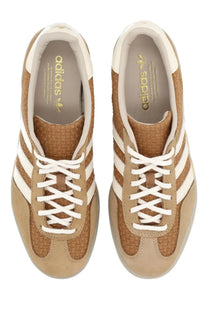 Adidas men’s gazelle indoor sneaker in beige featuring tan suede and woven textile with white stripes and laces