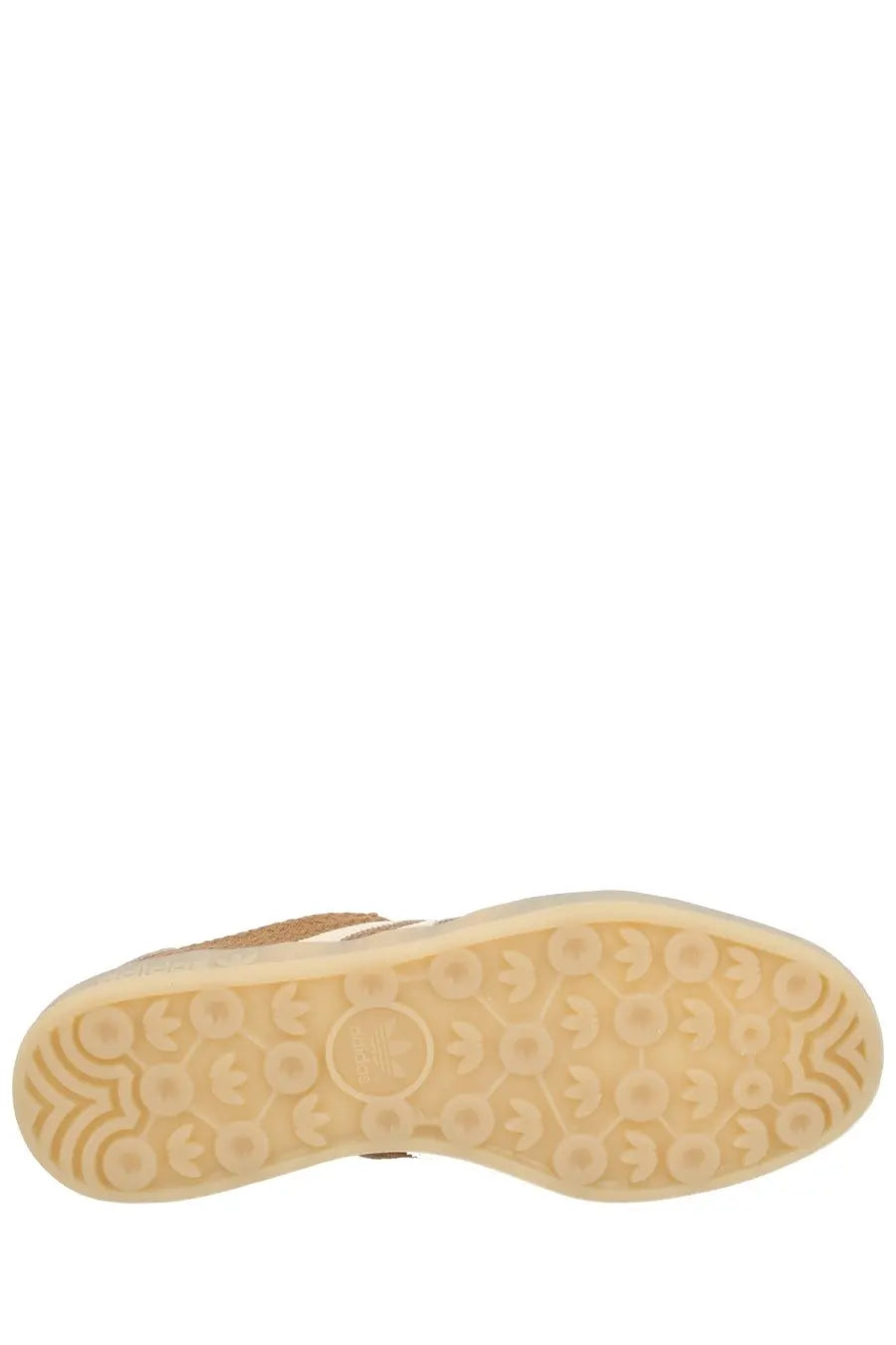 Back side of beige adidas men’s gazelle indoor sneaker with textured rubber sole featuring logo patterns and heel emblem