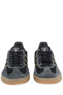 Adidas men’s Gazelle indoor sneaker in black and olive green suede with a gum rubber sole