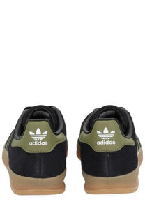 Adidas men’s Gazelle indoor sneaker in black suede with olive green heel tabs and gum-colored rubber soles back view