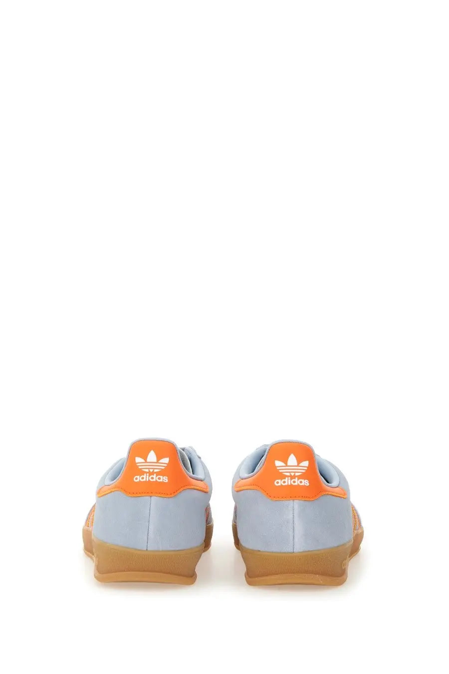 Light blue adidas men’s gazelle indoor sneakers with orange heel tabs and gum-colored soles shown from the back