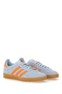 Adidas men’s gazelle indoor sneaker in light blue suede with vibrant orange stripes and gum rubber sole