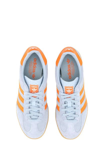 Adidas men’s gazelle indoor sneaker in light gray and orange with suede upper and rubber sole featuring three stripes