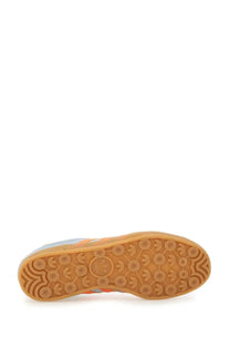 Adidas men’s gazelle indoor sneaker in orange and gray with gum rubber sole and three-stripe logo pattern