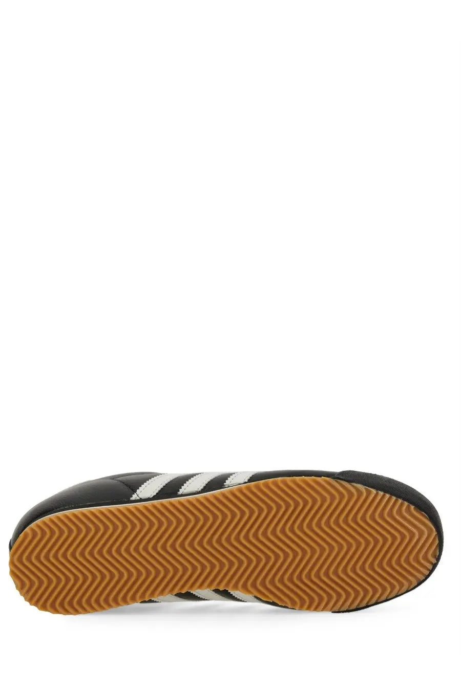 Adidas men’s kick sneaker black leather with white stripes and tan rubber sole for casual wear