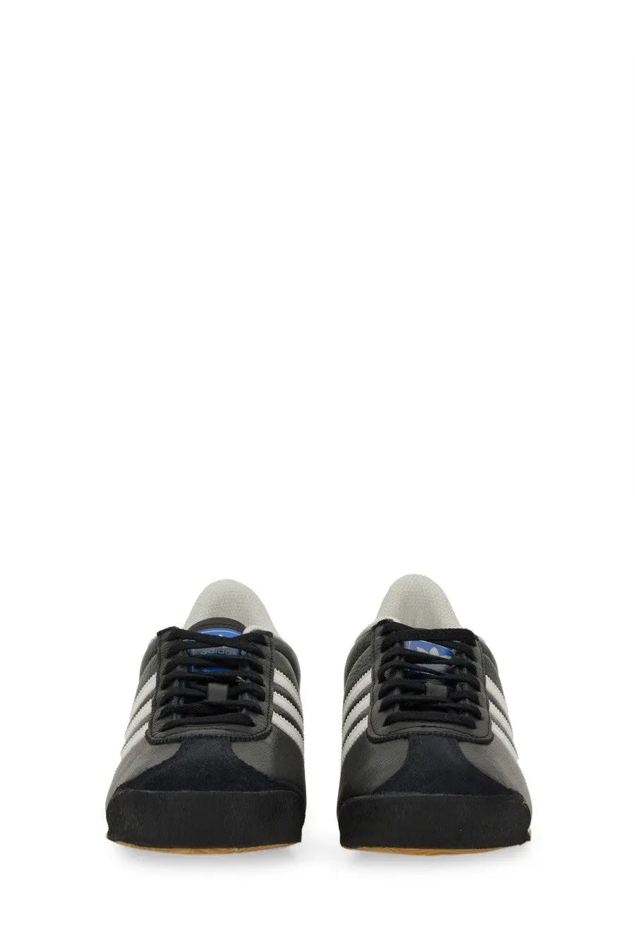 Adidas men’s kick sneaker black featuring white stripes and a light gray tongue in a sleek athletic design