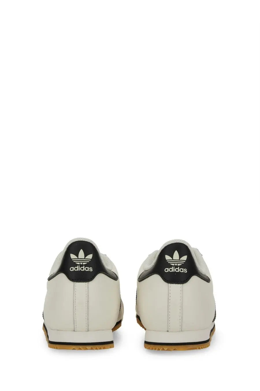 Adidas men’s kick sneaker white featuring white leather samba sneakers with black heel tabs and gum rubber soles