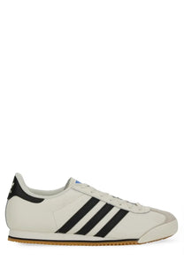 Adidas men’s kick sneaker white with black three stripes gray accents and gum rubber sole white samoa design