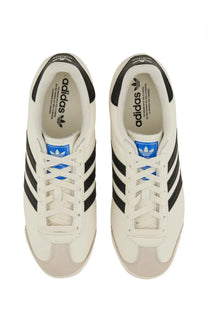 Adidas men’s kick sneaker white featuring white leather with black three stripes and blue branding accents