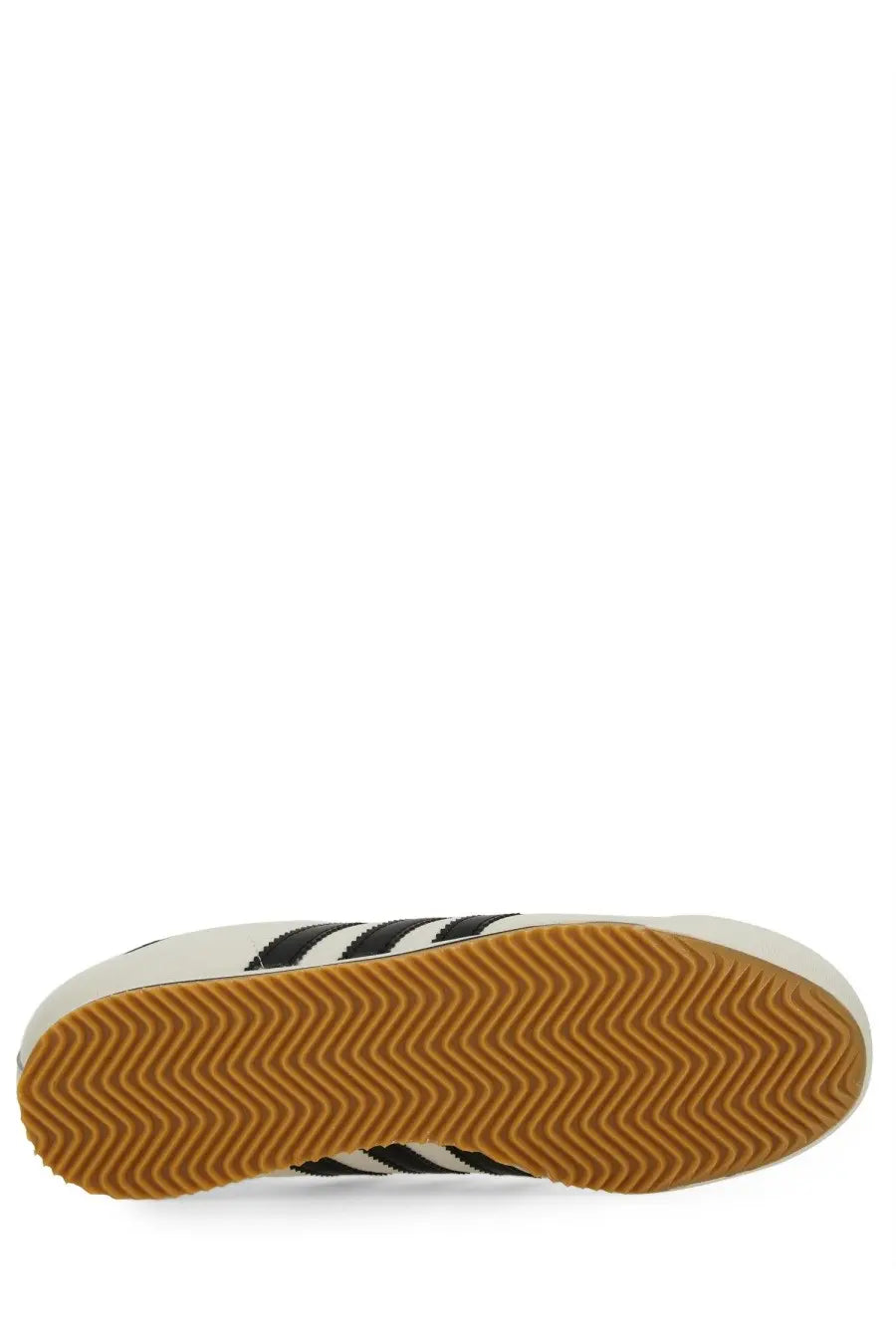 White adidas men’s kick sneaker with black stripes and tan rubber sole in a classic low-top design