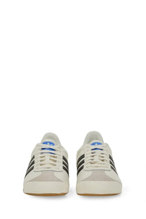 Adidas men’s kick sneaker white with black stripes and blue tongue accents in a lightweight design