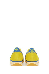 Adidas men’s sneaker in bright yellow with blue accents and gum-colored sole in a multicolor design