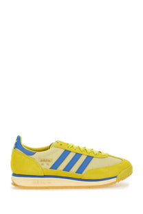 Vibrant yellow adidas men’s sneaker with bold blue stripes and suede accents in multicolor design