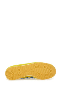 Adidas men’s multicolor sneaker showing yellow rubber sole with circular tread patterns and Adidas logo near heel
