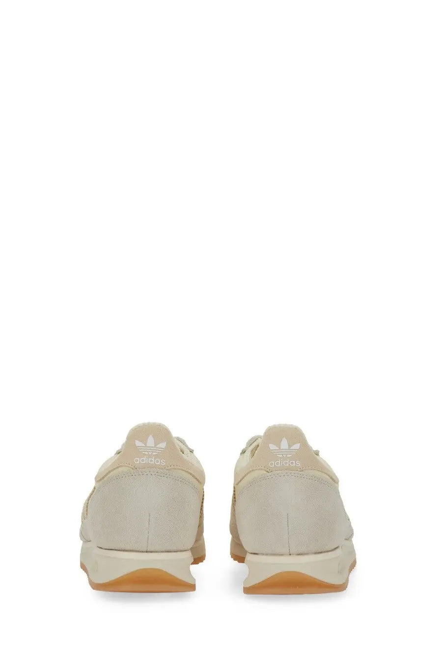 Beige adidas men’s sneaker with gum rubber sole and white branding on the heel shown from the back side