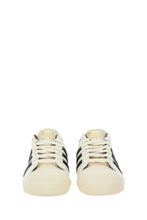Cream-colored adidas Originals by Wales Bonner men’s Superstar sneakers with black stripes and gold-toned branding