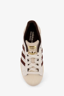 Cream-colored adidas Originals by Wales Bonner leather sneakers with maroon stripes and gold-toned heel tab white