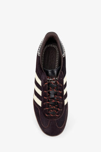 Dark brown suede adidas originals by wales bonner unisex wb gazelle sneakers with white stripes and red black laces